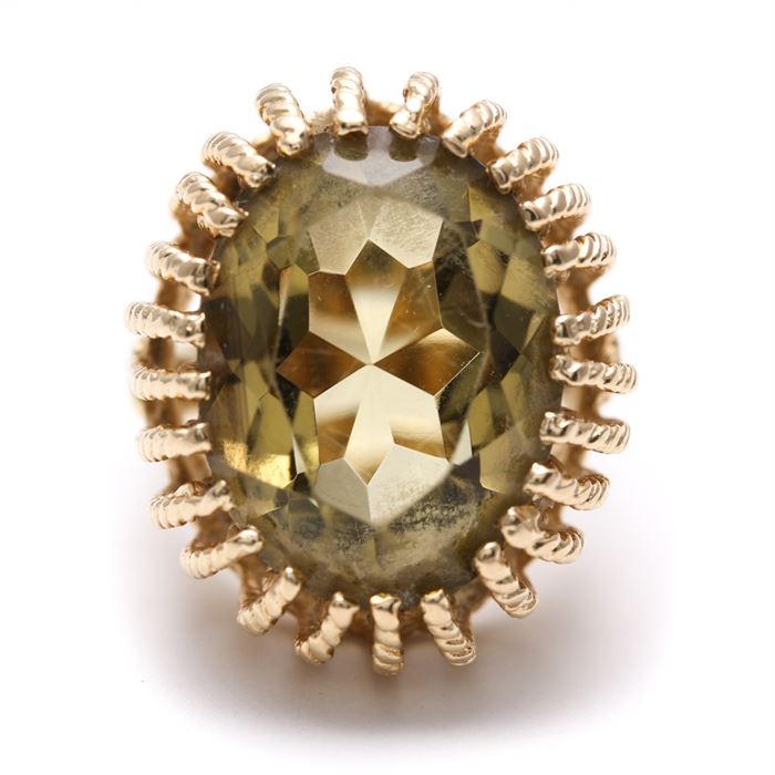 14K Yellow Gold Citrine Ring: A 14K yellow gold ring features a multi-pronged crown that holds a faceted oval citrine.