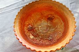 Carnival glass with fluted edge; orange iridescent 