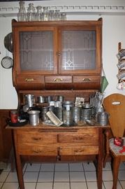 Beautiful antique hoosier with collection of antique flour sifters