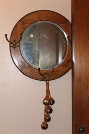 Antique wall mirror with brass hooks