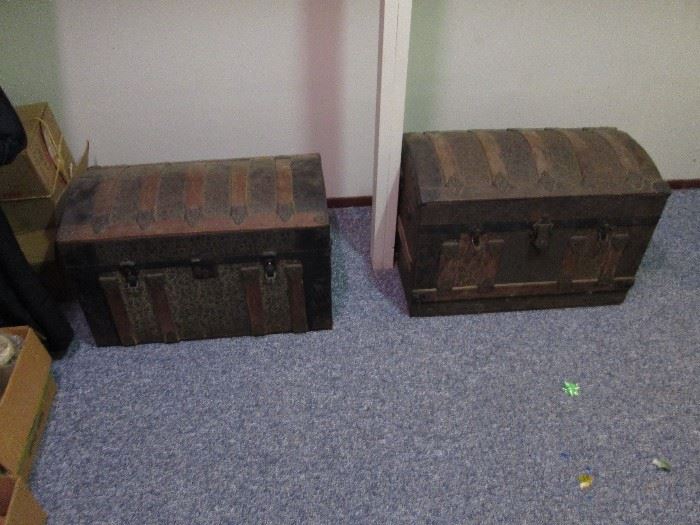 Two of four dome top trunks