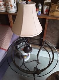 Wrought iron lamp with shade and Glass Round Table with Wrought Iron feet.