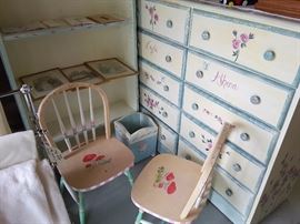 Girl's painted 10 drawer dresser, matching 5 shelf dresser, two chairs, waste basket.