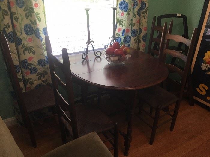 Gate leg table with 4-ladder back chairs, candle stands, faux fruit in bowl