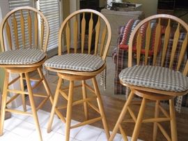 set of three bar stools with cushions