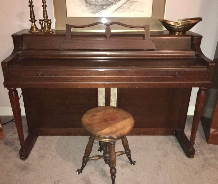Wurlitzer console piano and antique swivel stool with glass clawfeet