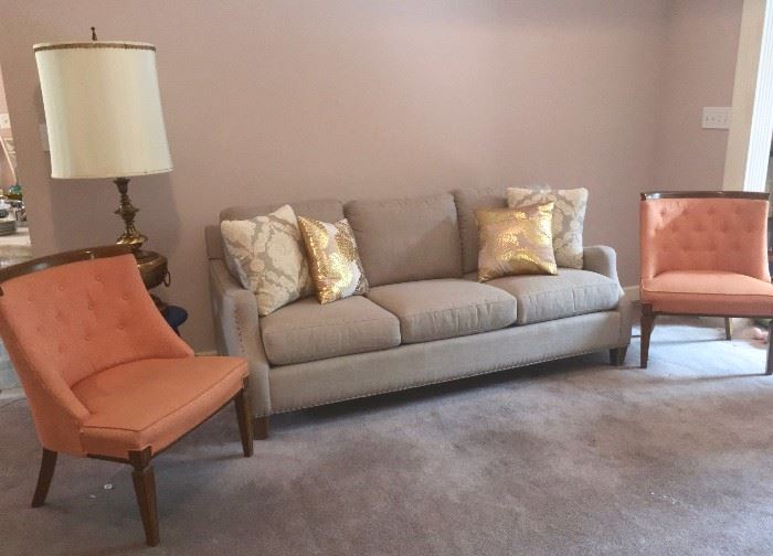 Like-new contemporary sofa embraced by a pair of retro side chairs, also in excellent condition