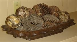 Pinecones and feather balls in wooden bowl