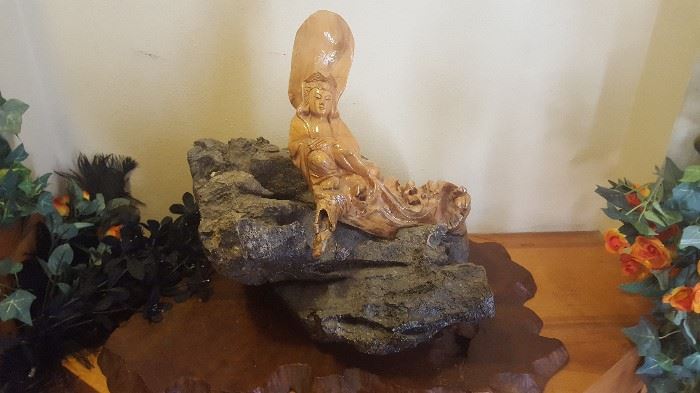 Carved Wooden Figure on Solid Rock