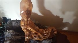 Carved Wooden Figure on Solid Rock