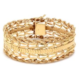 Vintage 14K Yellow Gold Wide Multi Chain Link Bracelet with Box: A vintage 14K yellow gold wide multi chain link bracelet, comprised of twisted rope chains to the outer edge, with oval links flanking an engraved diamond link pattern to center. The bracelet comes presented in a vintage purple velvet box.