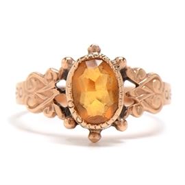 Victorian 10K Rose Gold Citrine Ring: An antique Victorian 10K rose gold ring featuring a bezel-set citrine with accentuating details to the mounting and shoulders.