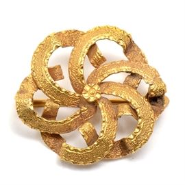 Early 20th Century 14K Yellow Gold Swirled Flower Pin: An early 20th century 14K yellow gold swirled flower pin featuring a high gold wash.