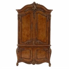 Henredon Home Entertainment Cabinet: A Henredon cabinet for a home entertainment system. It features a main cabinet with double doors, with one fixed shelf and two adjustable shelves, above two lower cabinets with one fixed shelf to the left and two drawers to the right. In oak, with ornate carved accents. It matches the bed frame in lot 135.