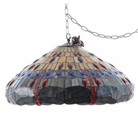 Stained Glass Hanging Shade: A stained glass hanging shade in green, blue and carmel, accented with red and multi-colored, elliptical cabochon jewels. Direct wired, includes chain and ceiling canopy.