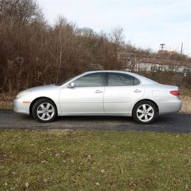 2005 Lexus ES330 Sedan: A 2005 Lexus ES330 mid-size sedan featuring a 3.3L V6 5-speed automatic transmission with overdrive front wheel drive. VIN is JTHBA30G055095768 with the odometer reading 214279. Silver exterior with black leather interior. Includes spare and emergency tool kit in the trunk, electronic sunroof, power windows, driver seat controls with memory setting, power mirrors, and a premium Lexus sound system with AM/FM radio, cassette, CD player, and steering wheel controls.