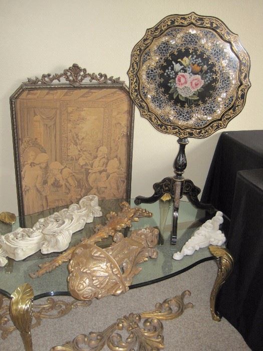 Tilt top table with mother of pearl inlay. Framed tapestry. Glass top coffee table. Accent pieces.