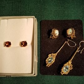 Tourmaline stud earrings, Opal earrings surrounded by blue sapphires, and Aquamarine pendant earrings