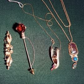 Left to right:  Gold & Diamond pin, Madeira Citrine pin, Topaz & rubies pendant on gold chain, Opal pendant on gold chain.