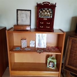 Bookcase with valentines.  Music boxes and Clouet Print that appears to be Elizabeth of Austria