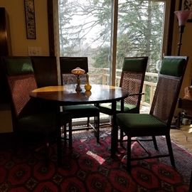 Mid-century dining table with 4 of the 6 chairs shown.  Comes with 2 wide leaves (one is visible behind left chair, leaning against wall beneath light switch).  No label or manufacturer information found.
