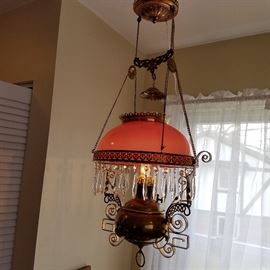 Hanging lamp (electrified) with pink glass shade that appears to be Ca. 1890.