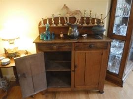 This cabinet shows hand hewn marking and has a wonderful patina