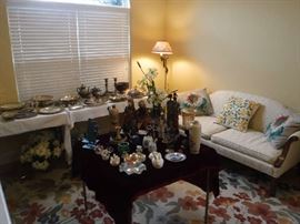 Very pretty sofa and on the left is a selection of silver plate