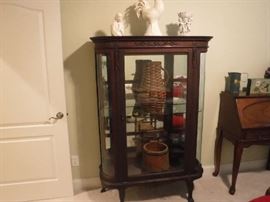 Curved glass cabinet all original glass. I had to remove glass to move this piece and only put back the middle shelf as it is not easy to get them out. The other 2 are in the back. Note the right front leg is a weak point and will need bracing at some point if in an area that the cabinet moves.