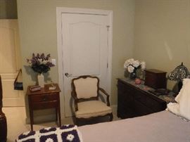 Nice bedroom chair the other in this room is floral. We also have what appears to be a selection of Polo Green/"Leather" luggage