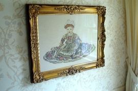 Needle work picture of young girl in antique gilt frame.