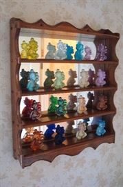 Wall display of colored glass figures.