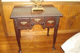 Antique Queen Anne table with pad feet and three drawers.