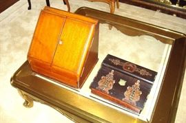 On the left a victorian stationary holder and on the right an antique lap desk inlaid with mother of pearl.