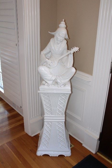Porcelain statue on pedestal-man playing instrument