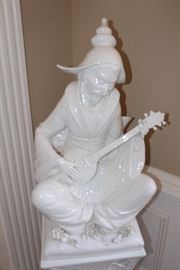 Porcelain statue on pedestal-man playing instrument