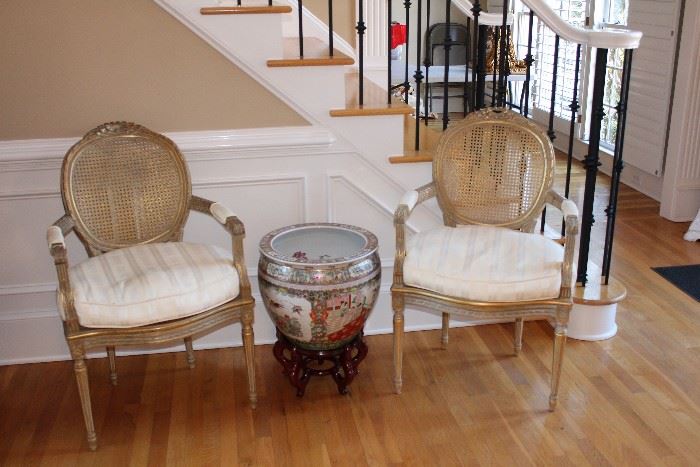 Pair of caned and cushioned chairs, Porcelain painted pot on wooden stand