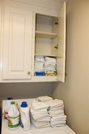 Assorted cleaning products, wash cloths, and cleaning rags