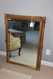 Gilt hanging mirror with beveled glass