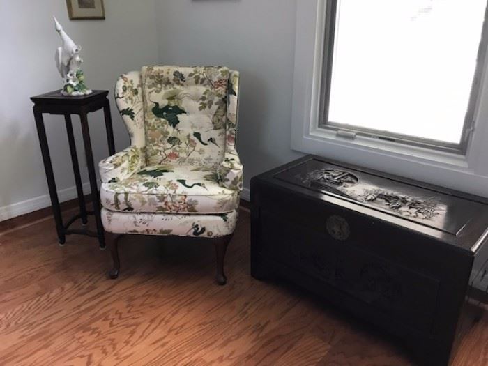 Plant stand, one of two wing back chairs and trunk