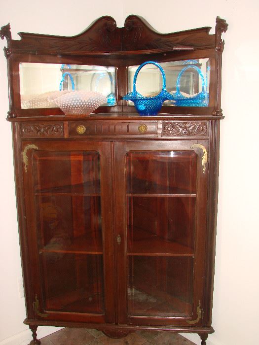 Unusual Mahogany Victorian Corner China Cabinet with carved griffins, brass ormalu dragons and beveled mirrors. A rare find.