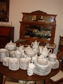 Huge set of Haviland China and behind it another beautiful carved oak buffet
