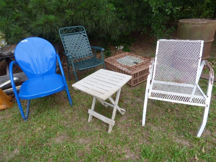 Sample of outdoor chairs, chicken transport coop in back