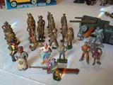Lead toy figures circa early 1900's through 1930's, from left to right: Cowboys, black woman, "Doughboy" soldiers from WWI & WWII; pirate figures; toy car jack; "Buck Rodgers" cast figure and other figures with Rapaport Bros. of Chicago "Buck Rogers Junior Caster Set" lead mold; pair of ice skaters.