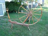 This is the real deal, NOT A REPRODUCTION, but a real antique spinning wheel with a gorgeous patina that only comes from age. This large spinning wheel dates back to another time in this country when wool was spun into thread on these wheels. This solid wood spinning wheel features hand lathed wood components with spools to collect the wool.