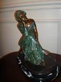 Another original brass sculpture which sits approximately 18" high from top to bottom is signed by the artist in the base.