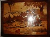Crafted with pieces of wood inserted like a mosaic. A much more beautiful work of art in person.