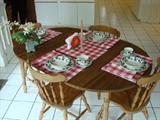 Lovely breakfast room dining set with four Windsor styled solid wood chairs.