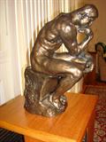 A casting reproduction of the actual small scale version of "The Thinker" done by famed sculpture, Rodin.