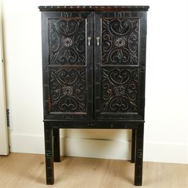 Wayborn Furniture Benfu Armoire: A Wayborn Furniture Benfu armoire, constructed of basswood. The front has a carved scroll design with drop pull brass handles. The inside is set up for a television or stereo. Legs are squared with flat feet.